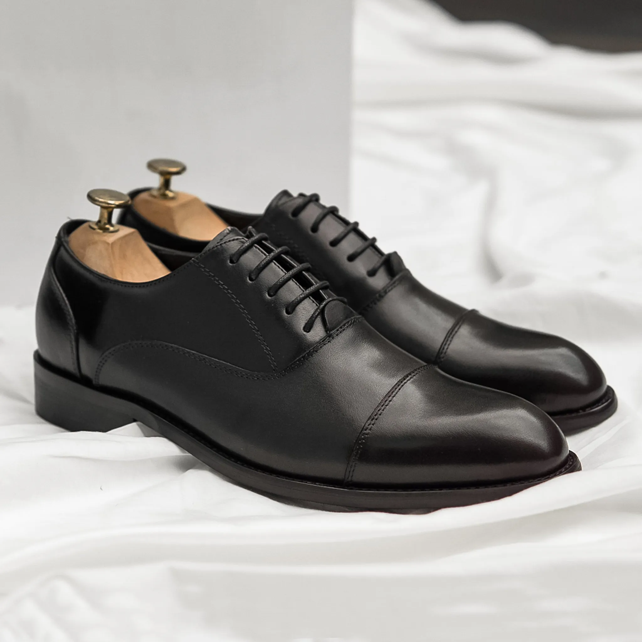 Black Oxford Cap Toe Lace Up shoe.